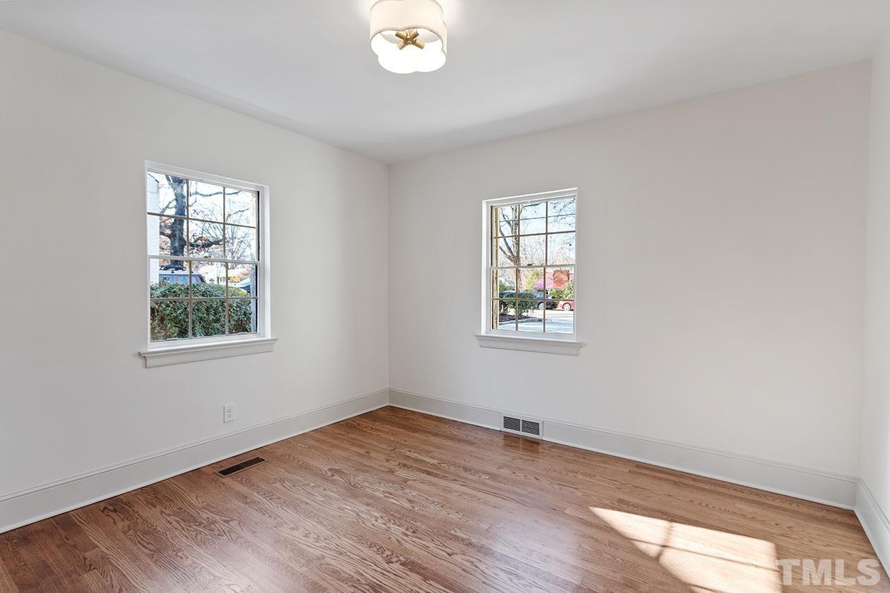 704 Dixie Trail Raleigh, NC 27607 - Photo 26 of 31 a view of an empty room with wooden floor and a window