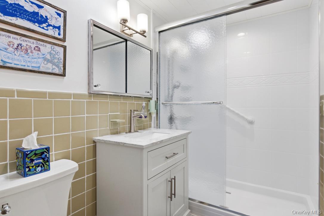3 Foster Avenue Hampton Bays, NY 11946 - Photo 12 of 20 a bathroom with a sink a toilet and shower