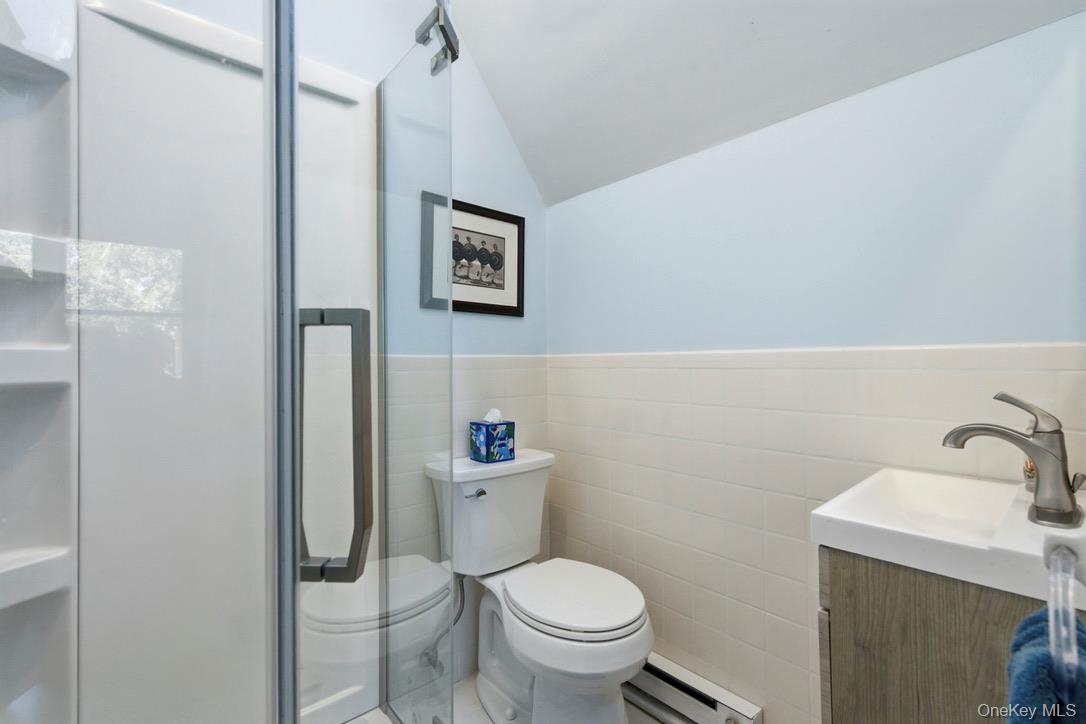 3 Foster Avenue Hampton Bays, NY 11946 - Photo 18 of 20 a bathroom with a toilet sink and vanity