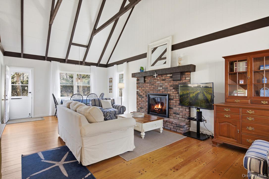 3 Foster Avenue Hampton Bays, NY 11946 - Photo 2 of 20 a living room with furniture and a fireplace