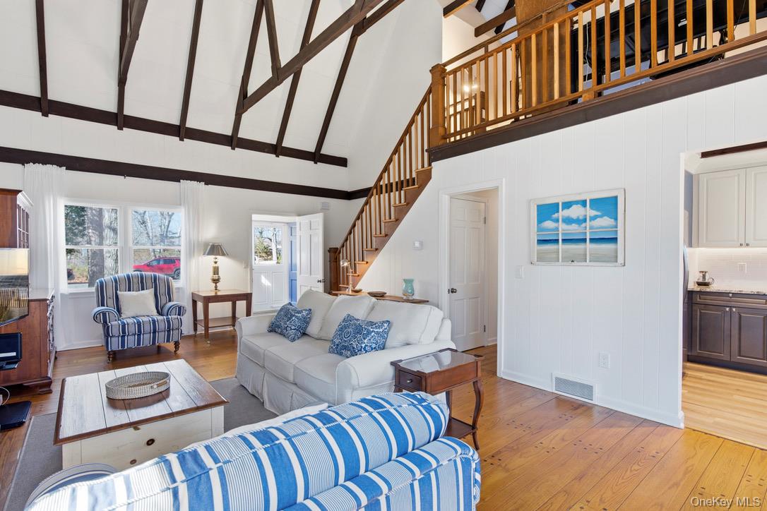 3 Foster Avenue Hampton Bays, NY 11946 - Photo 7 of 20 a living room with furniture and wooden floor