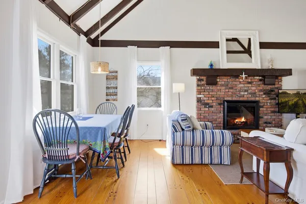 a view of a livingroom with furniture window and wooden floor