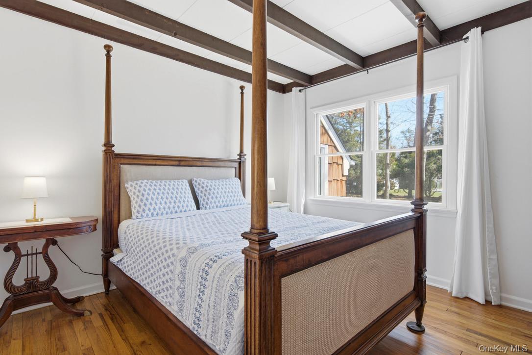 3 Foster Avenue Hampton Bays, NY 11946 - Photo 10 of 20 a bedroom with a bed and a window