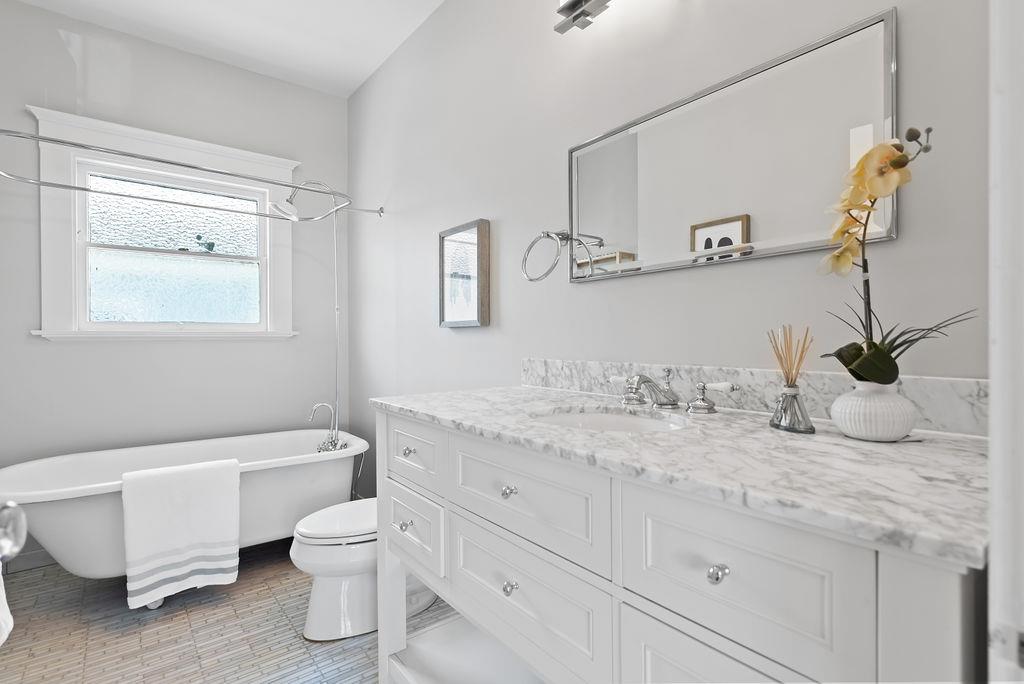 2800 Regent Street Berkeley, CA 94705 - Photo 26 of 40 a bathroom with a granite countertop toilet sink and mirror