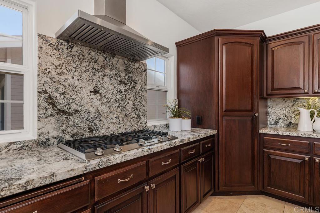 6456 Franciscan Road Carlsbad, CA 92011 - Photo 18 of 43 a kitchen with stainless steel appliances granite countertop a refrigerator and a stove