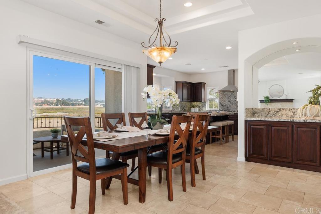 6456 Franciscan Road Carlsbad, CA 92011 - Photo 21 of 43 a view of a dining room with furniture window and wooden floor