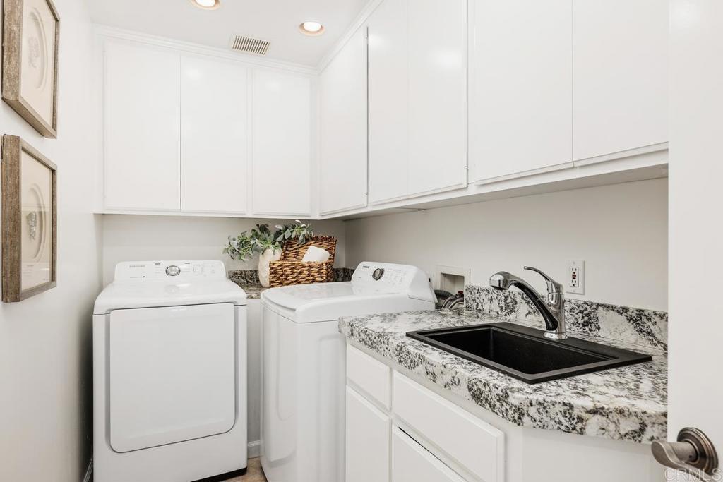 6456 Franciscan Road Carlsbad, CA 92011 - Photo 33 of 43 a kitchen with a sink a stove and cabinets