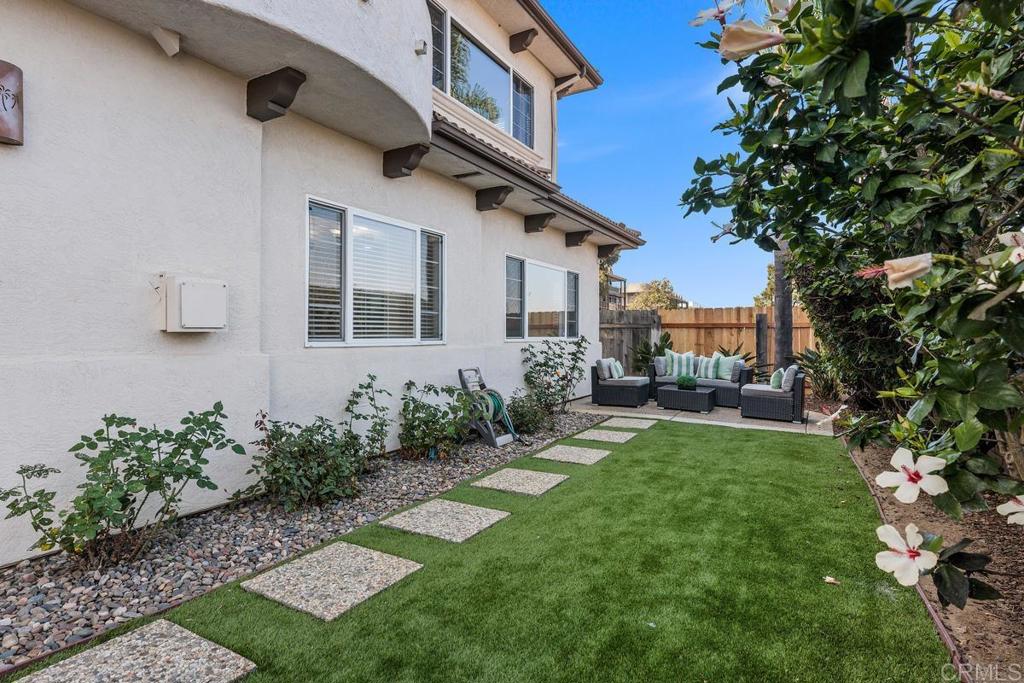 6456 Franciscan Road Carlsbad, CA 92011 - Photo 36 of 43 a backyard of a house with table and chairs plants