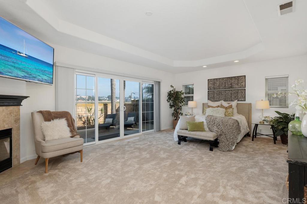 6456 Franciscan Road Carlsbad, CA 92011 - Photo 10 of 43 a bedroom with furniture and a fireplace