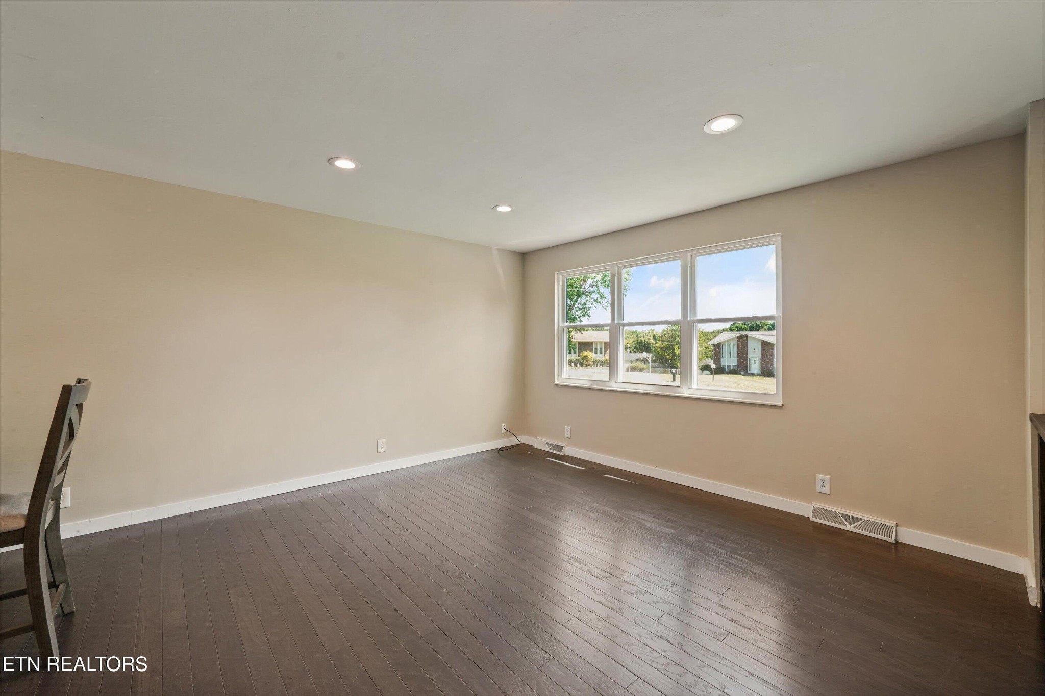 7613 Fall Wind Court Powell, TN 37849 - Photo 11 of 38 a view of an empty room with wooden floor and a window
