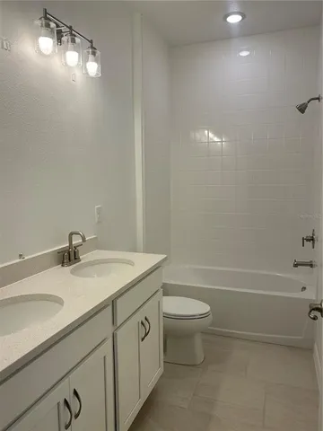 a bathroom with a sink a toilet and bathtub