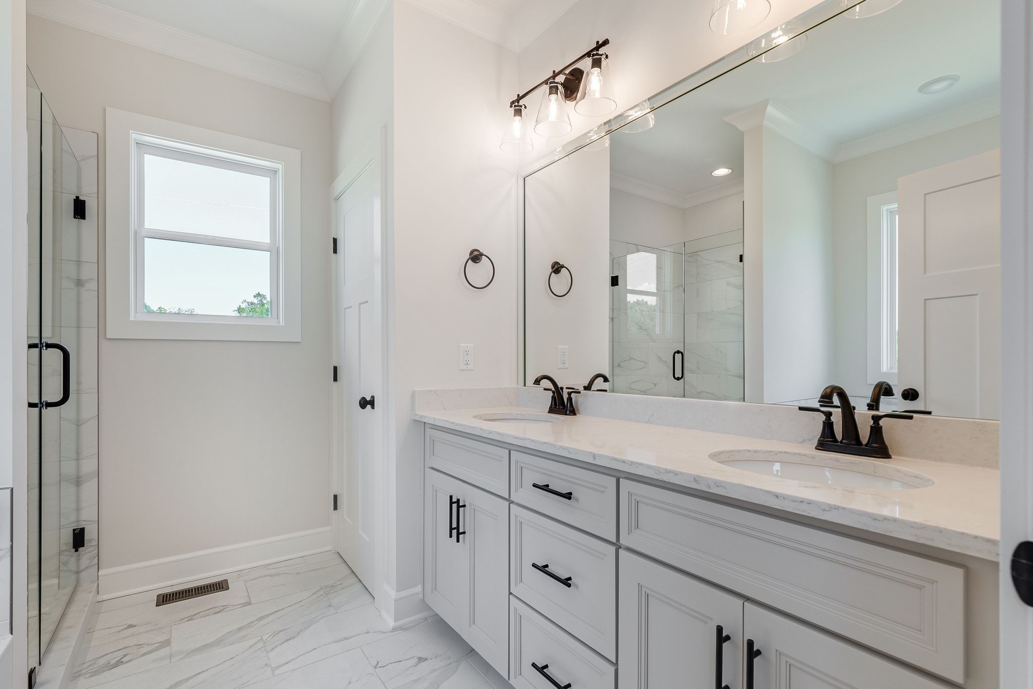 1563 Phillips Road Lebanon, TN 37087 - Photo 18 of 33 a bathroom with a double vanity sink and mirror with shower