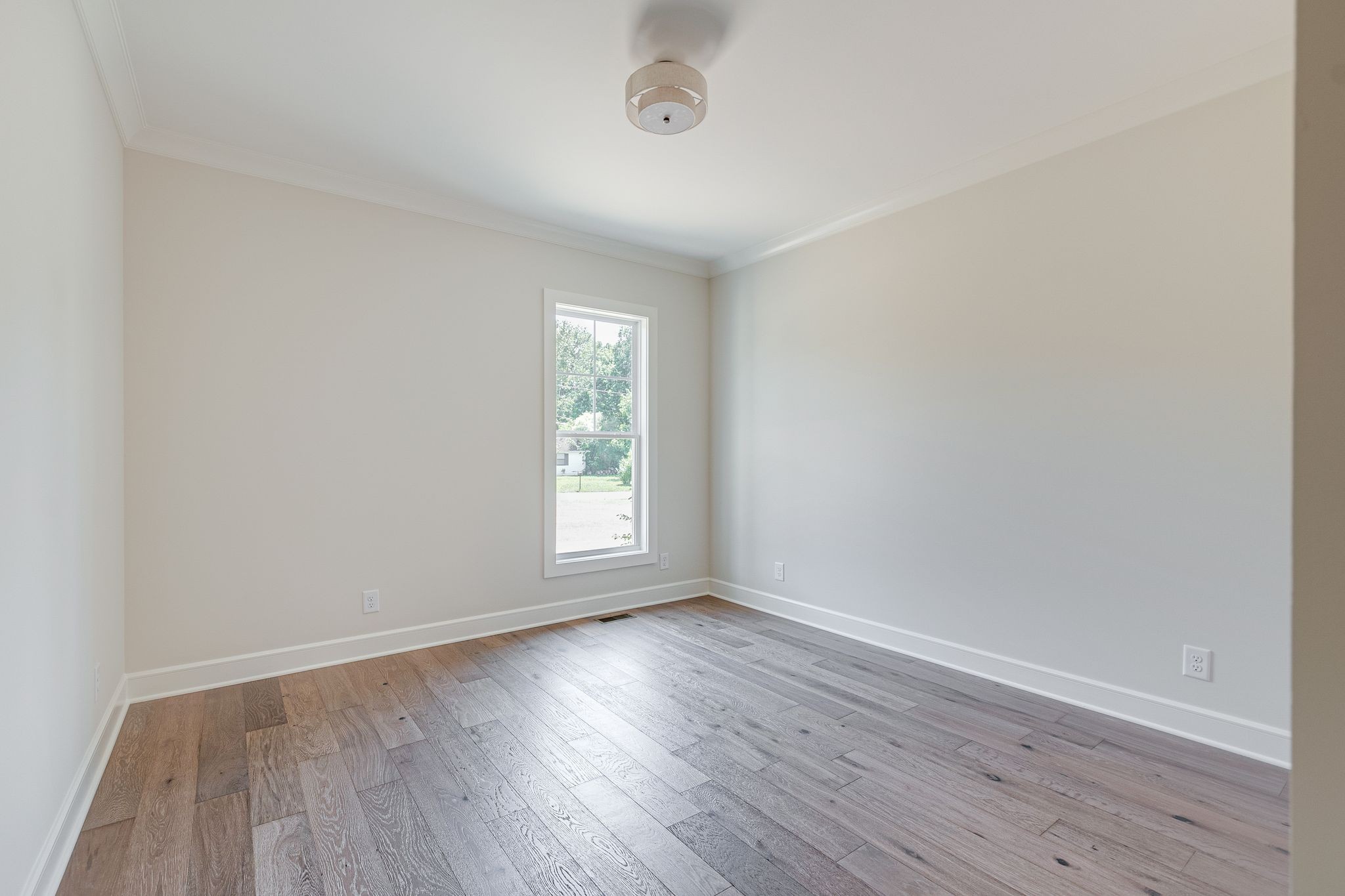 1563 Phillips Road Lebanon, TN 37087 - Photo 22 of 33 an empty room with wooden floor and windows