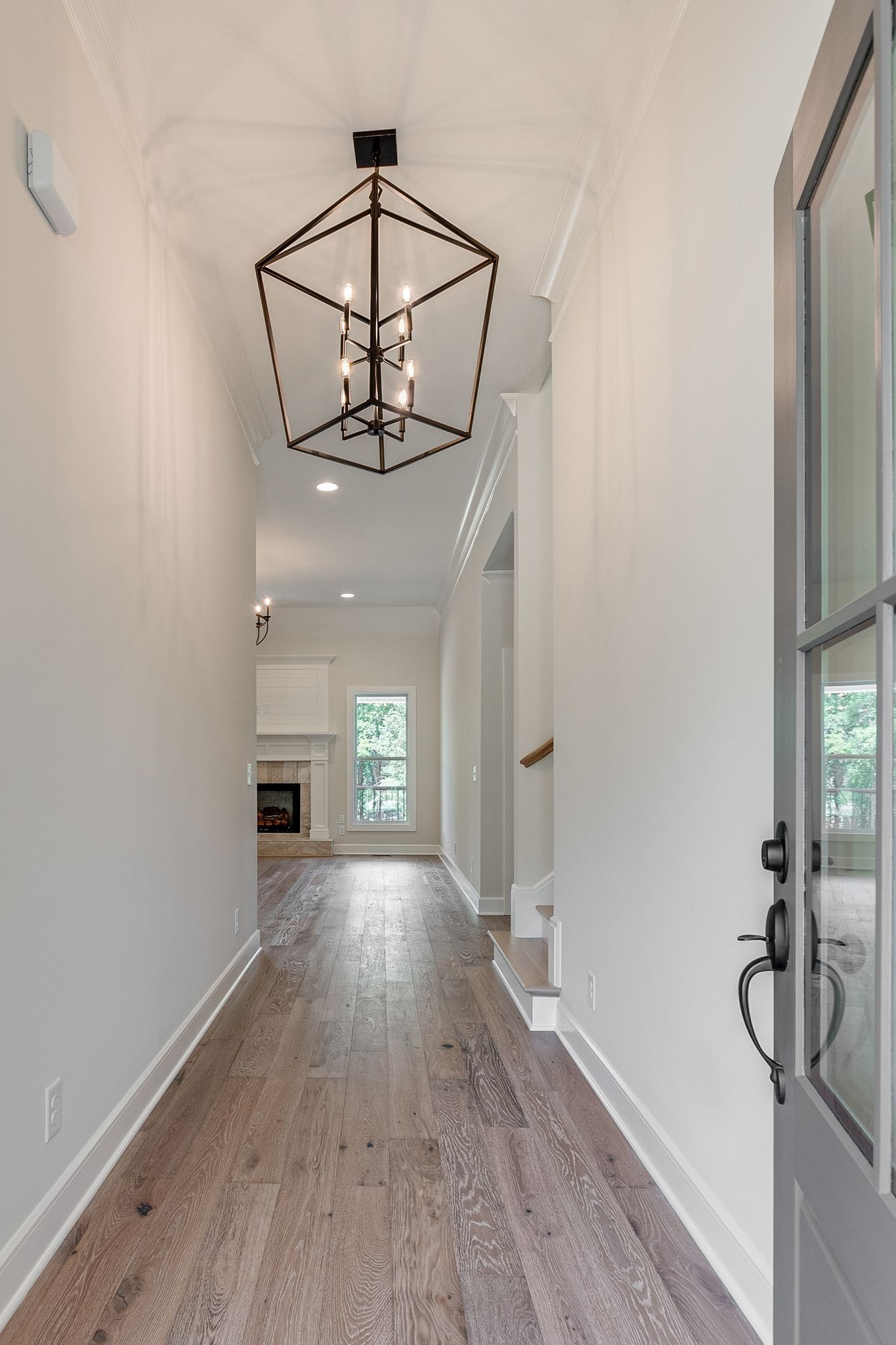 1563 Phillips Road Lebanon, TN 37087 - Photo 4 of 33 a view of a room with wooden floor staircase and a kitchen space