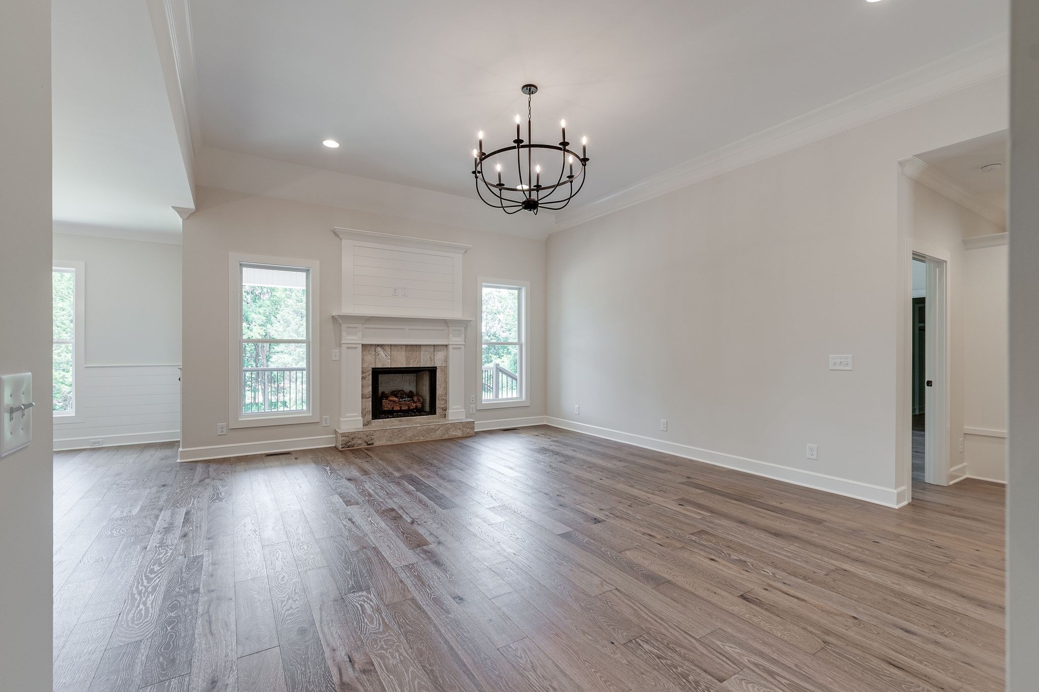 1563 Phillips Road Lebanon, TN 37087 - Photo 7 of 33 a view of an empty room with wooden floor fireplace and a window