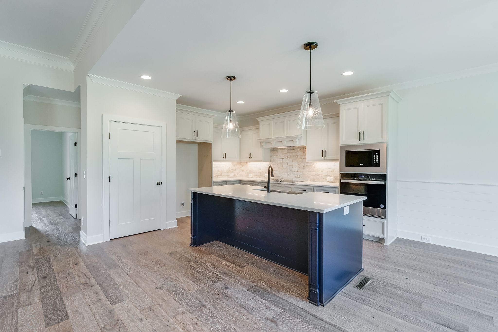 1563 Phillips Road Lebanon, TN 37087 - Photo 10 of 33 a kitchen with kitchen island stainless steel appliances a sink cabinets and wooden floor