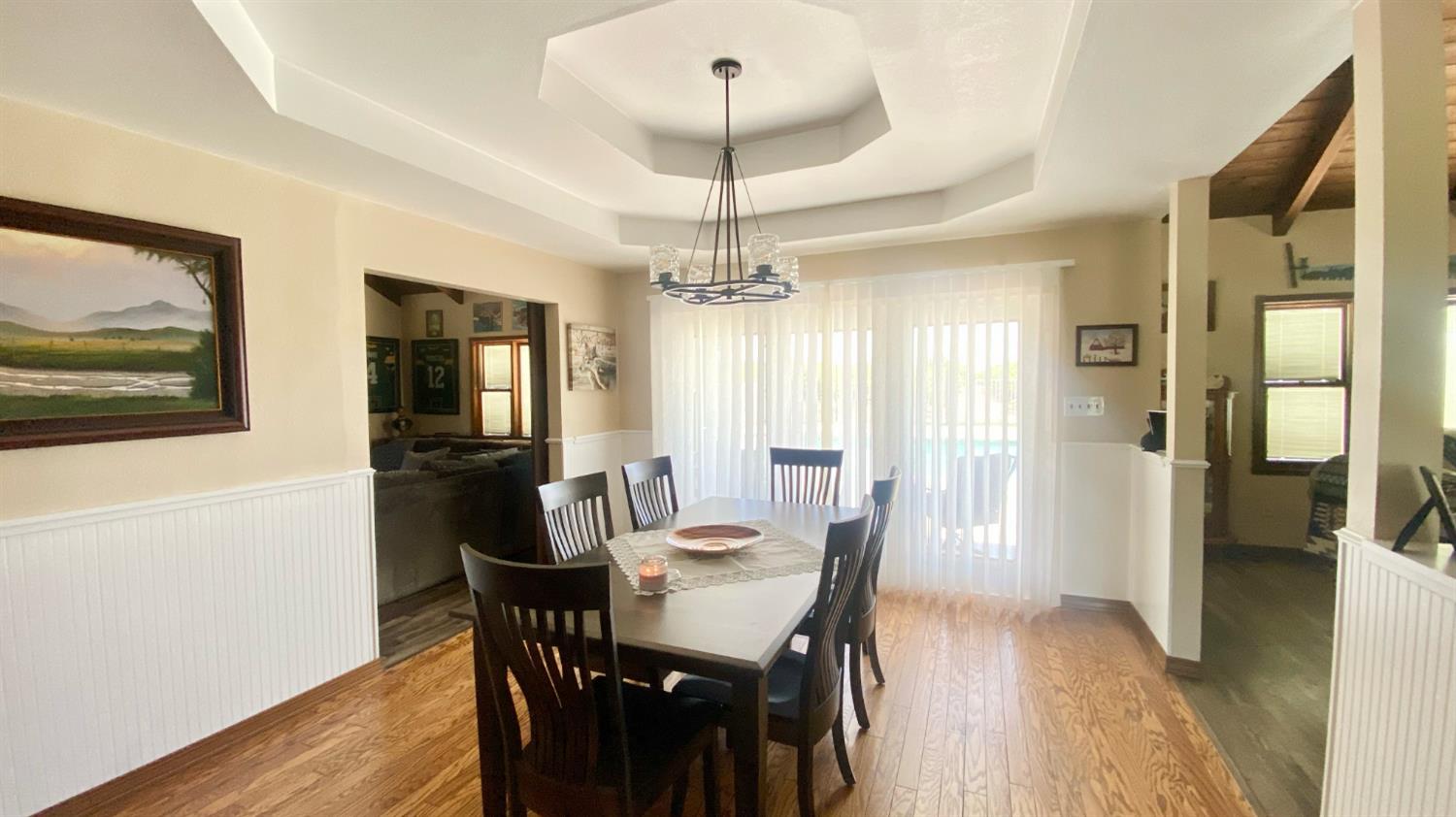 5012 Ustick Road Modesto, CA 95358 - Photo 16 of 26 a dining room with furniture a chandelier and wooden floor