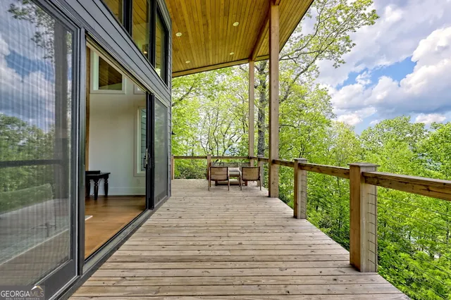 a kitchen with stainless steel appliances granite countertop a kitchen island hardwood floor sink stove dining table and chairs
