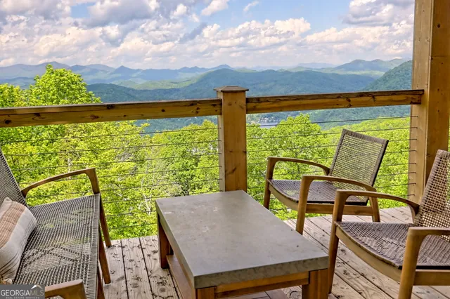 a kitchen with stainless steel appliances granite countertop a table chairs sink refrigerator and microwave