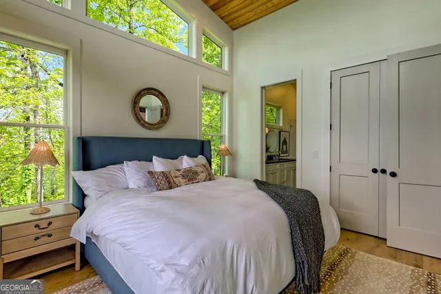 a bathroom with a shower a sink mirror and toilet