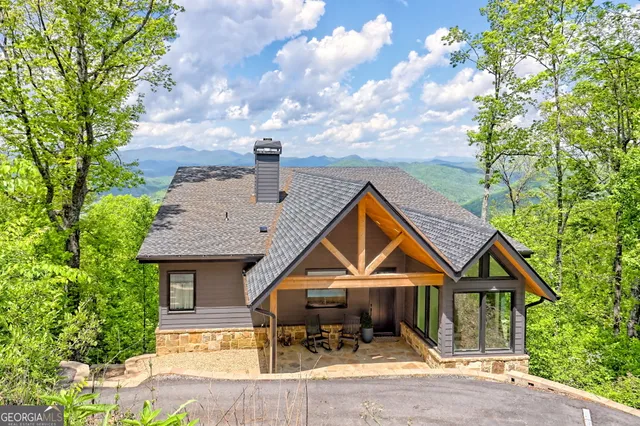 a view of a patio with couple of chairs and a potted plant