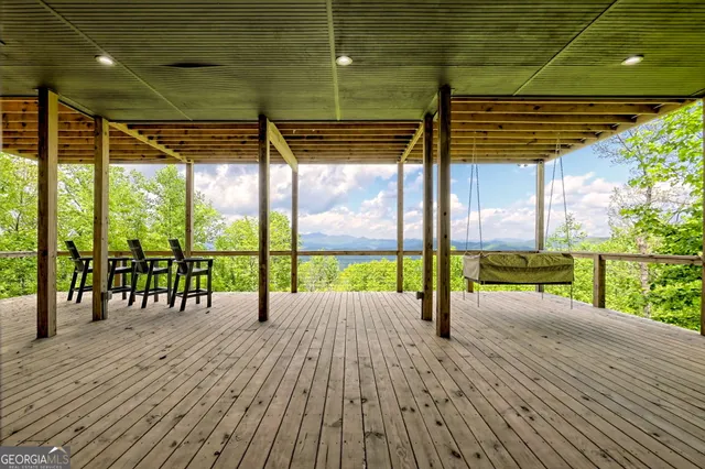 a view of house with roof deck and seating space