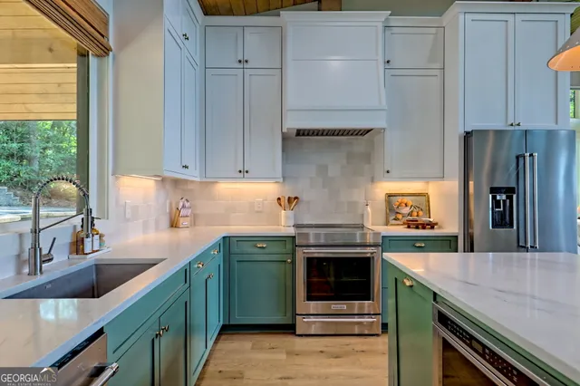 a kitchen with stainless steel appliances a stove and a refrigerator