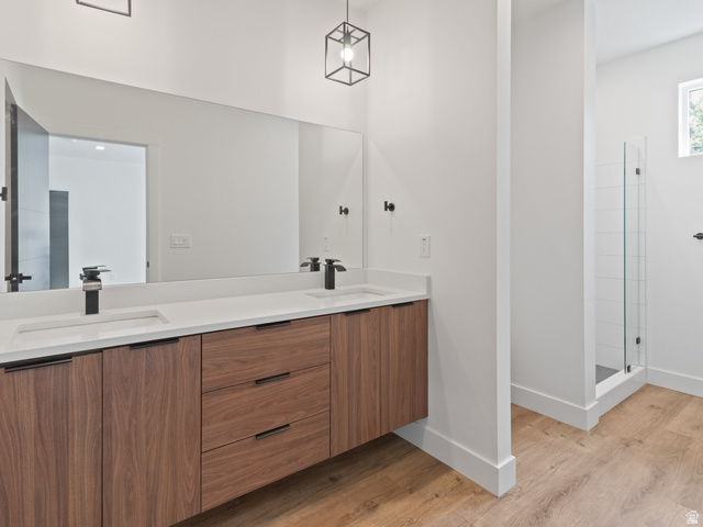 130 East 7085th South, Unit 3 Midvale, UT 84047 - Photo 4 of 30 Full bath with double vanity, a tile shower, and light wood-style floors