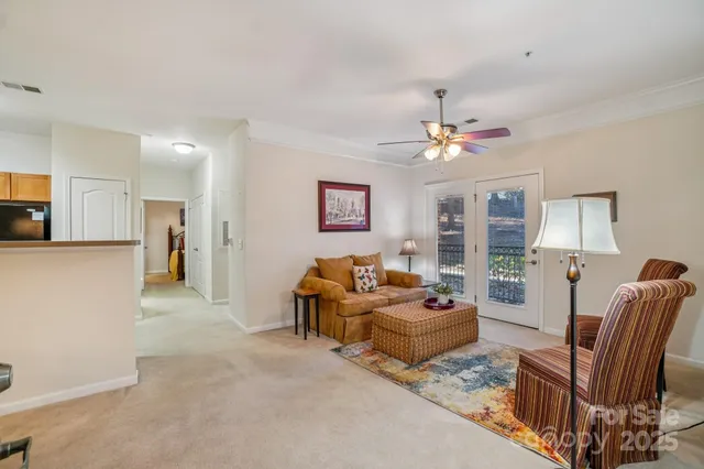 a living room with furniture and a chandelier