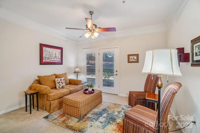 a living room with furniture a couch and a lamp