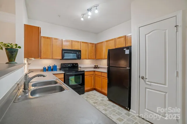 a kitchen with a refrigerator a stove top oven a sink and dishwasher
