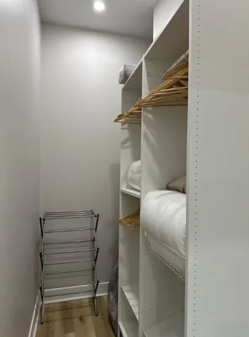 a bedroom with a bed and a refrigerator