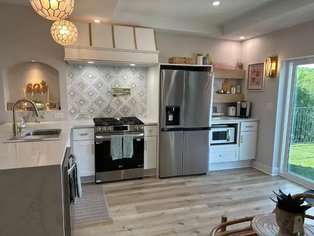 a kitchen with a stove and a refrigerator