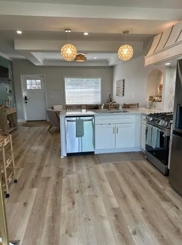 a kitchen with granite countertop a stove and a sink