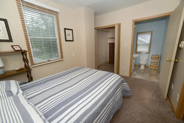 a bedroom with a bed and a mirror