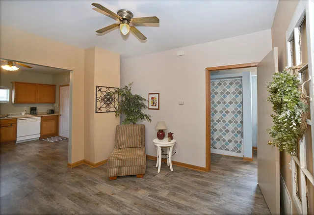 a living room with furniture and a potted plant