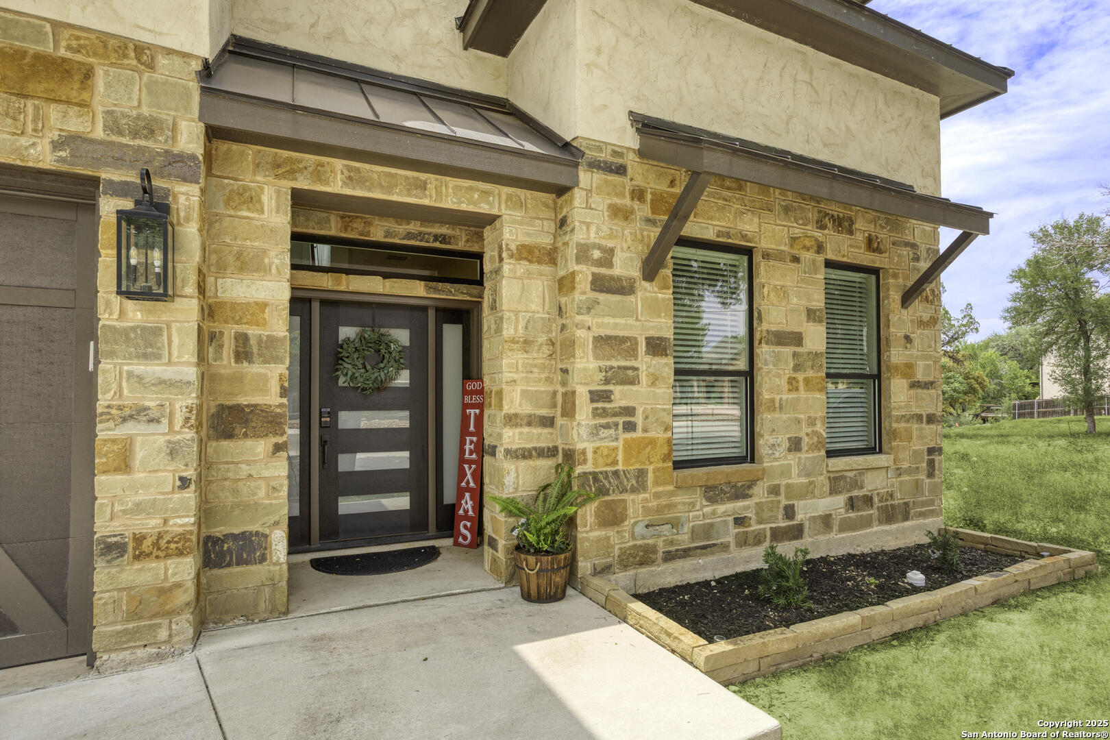 front view of a brick house with a outdoor shower
