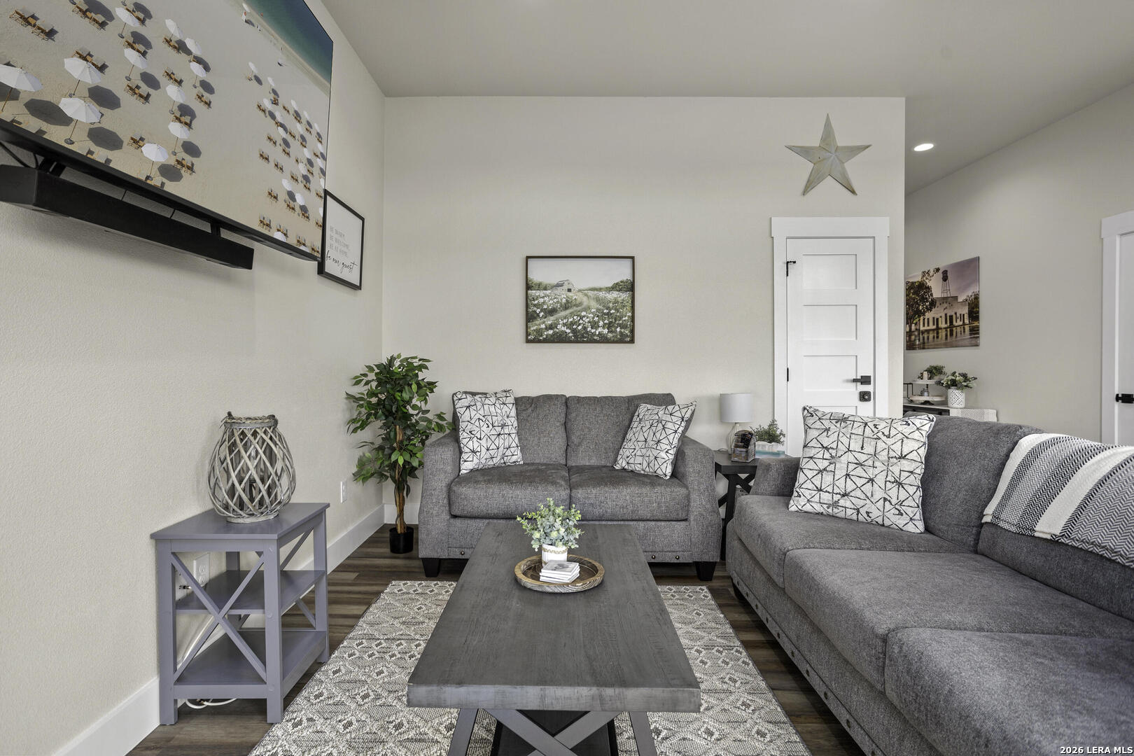 1121 Gruene Road, Unit A New Braunfels, TX 78130 - Photo 13 of 28 a living room with furniture a rug and a wall painting