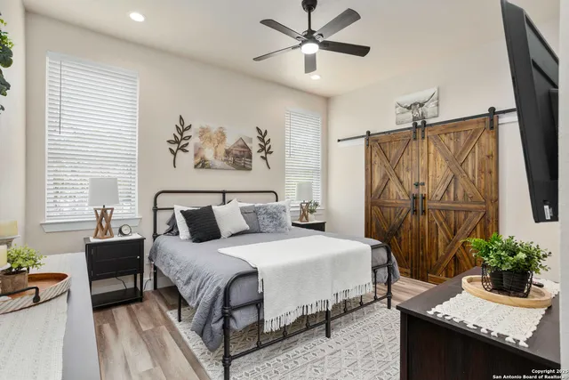 a bedroom with a large bed and a chandelier