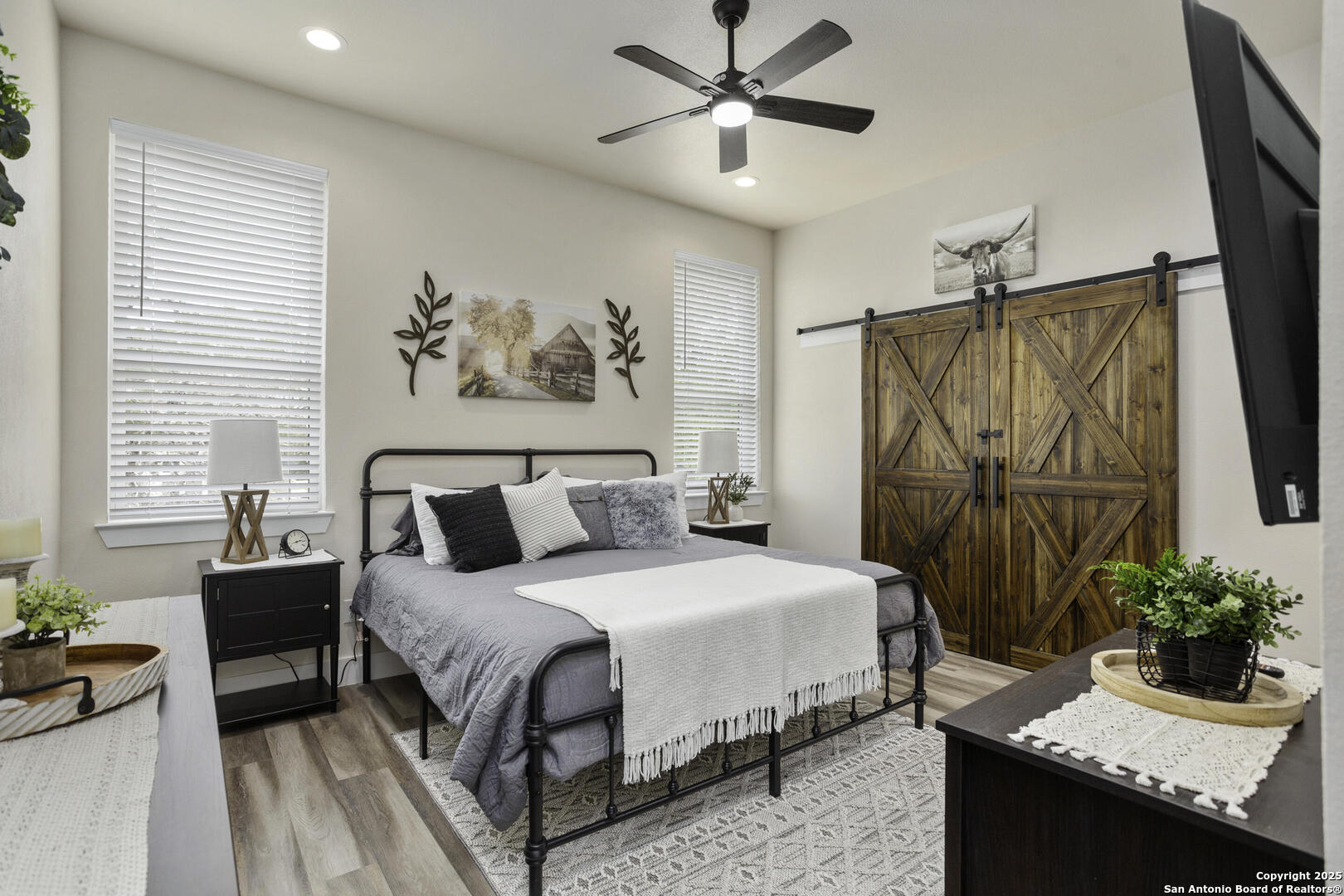 1121 Gruene Road, Unit A New Braunfels, TX 78130 - Photo 18 of 28 a bedroom with a large bed and a chandelier