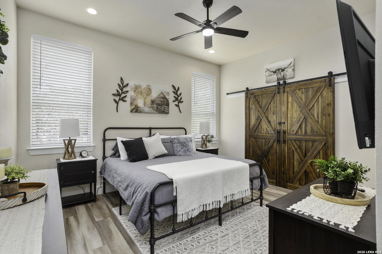 1121 Gruene Road, Unit A New Braunfels, TX 78130 - Photo 19 of 28 a bedroom with a large bed and a chandelier