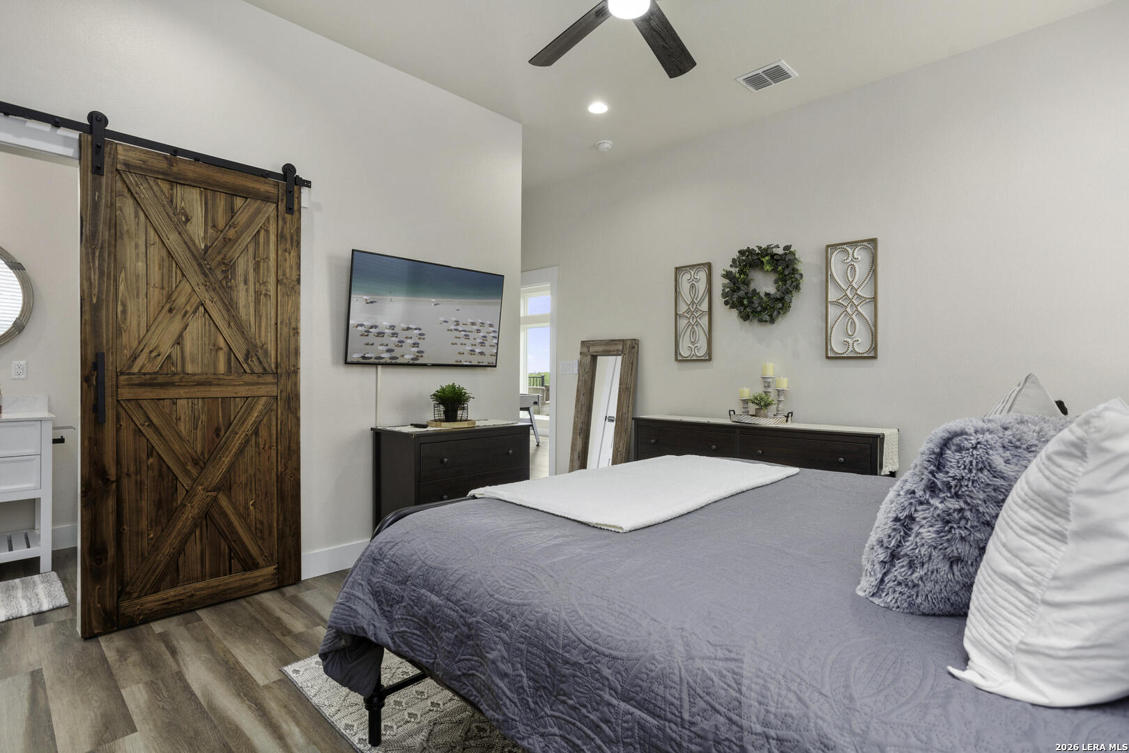 1121 Gruene Road, Unit A New Braunfels, TX 78130 - Photo 20 of 28 a bedroom with a bed and a mirror