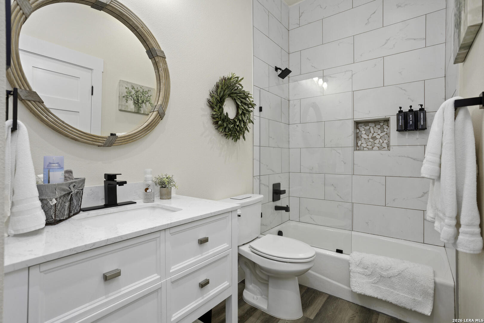 1121 Gruene Road, Unit A New Braunfels, TX 78130 - Photo 22 of 28 a bathroom with a granite countertop toilet sink and mirror