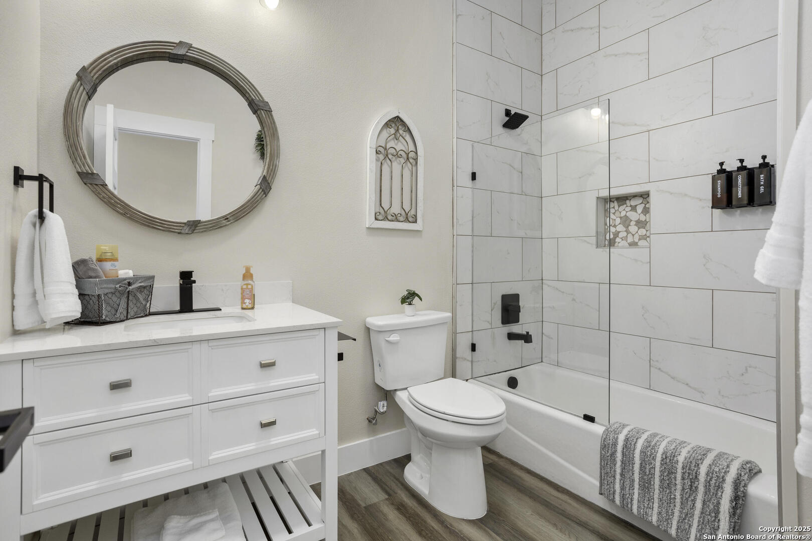 1121 Gruene Road, Unit A New Braunfels, TX 78130 - Photo 22 of 28 a bathroom with a toilet sink a mirror and vanity
