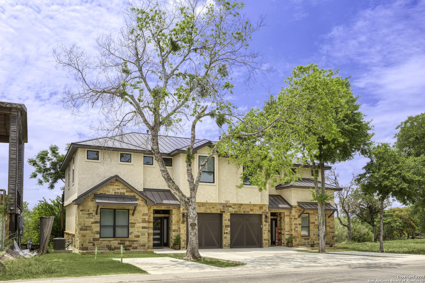 1121 Gruene Road, Unit A New Braunfels, TX 78130 - Photo 3 of 28 a front view of a house with a yard and garage