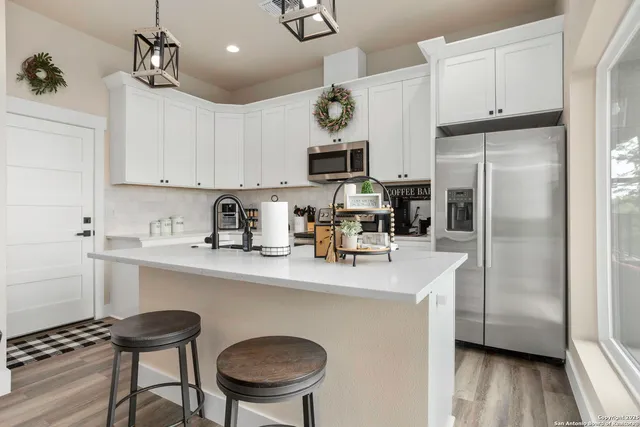 a kitchen with stainless steel appliances a refrigerator sink and cabinets