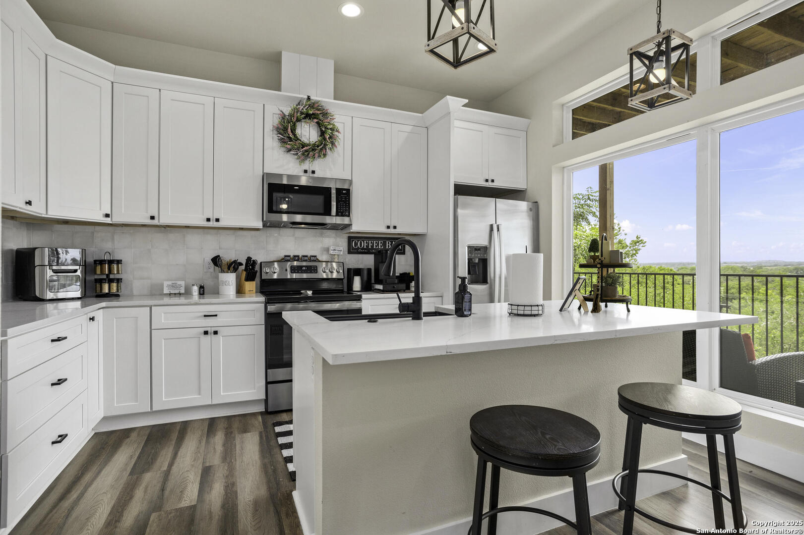 1121 Gruene Road, Unit A New Braunfels, TX 78130 - Photo 9 of 28 a kitchen with stainless steel appliances granite countertop a stove a sink dishwasher and white cabinets with wooden floor