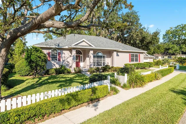 a front view of a house with a yard table and chairs