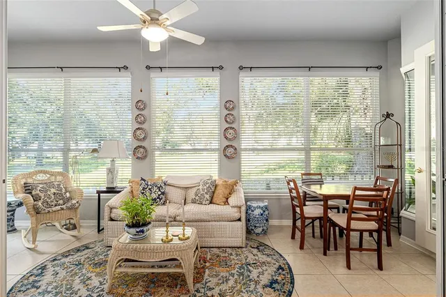 a living room with furniture and large windows