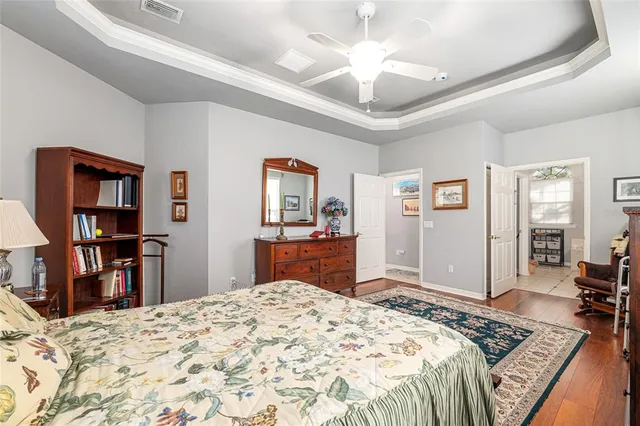 a bedroom with bed dresser and a window